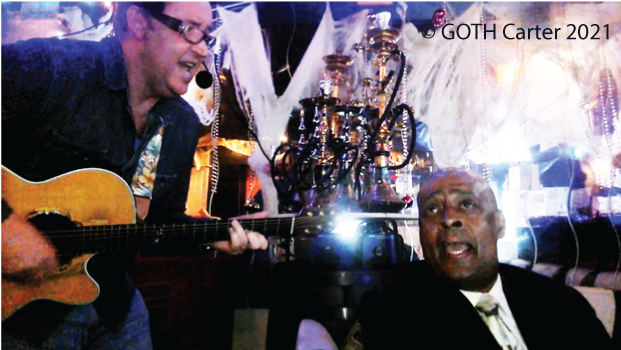 GOTH Carter performance photo with black fan singing duet together.